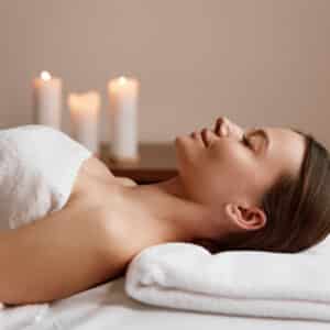 side view of peaceful woman relaxing in spa salon after massage